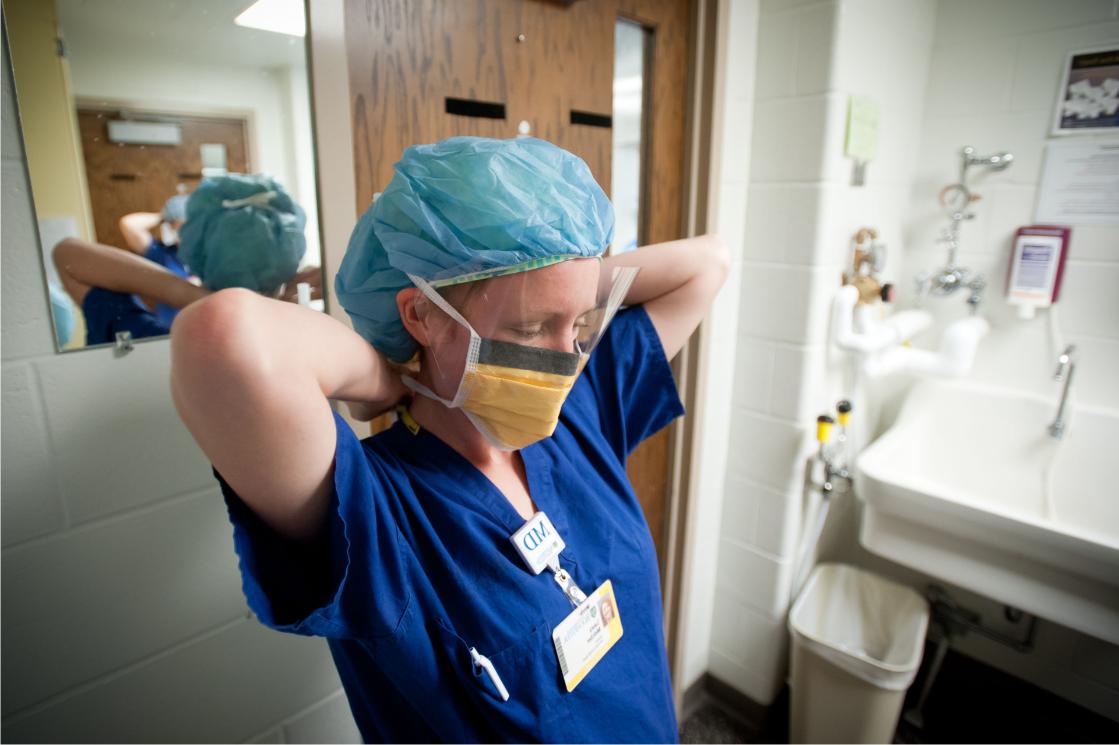 Medical resident putting on mask at University of Rochester Medical Center