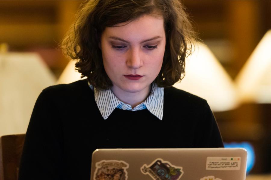 A student works on a computer in the library