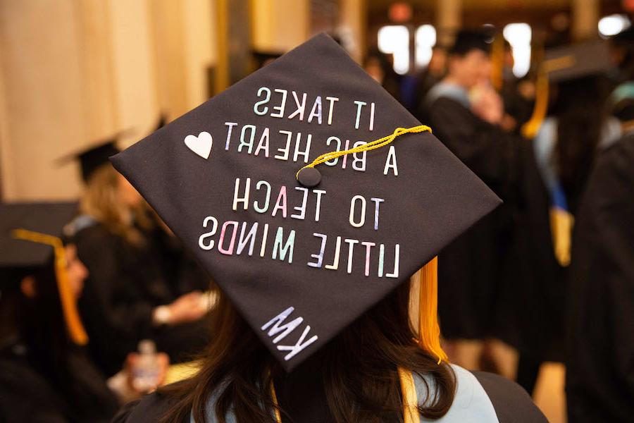 A Warner School of Education student's graduation cap, decorated to read, It takes a big heart to teach little minds.